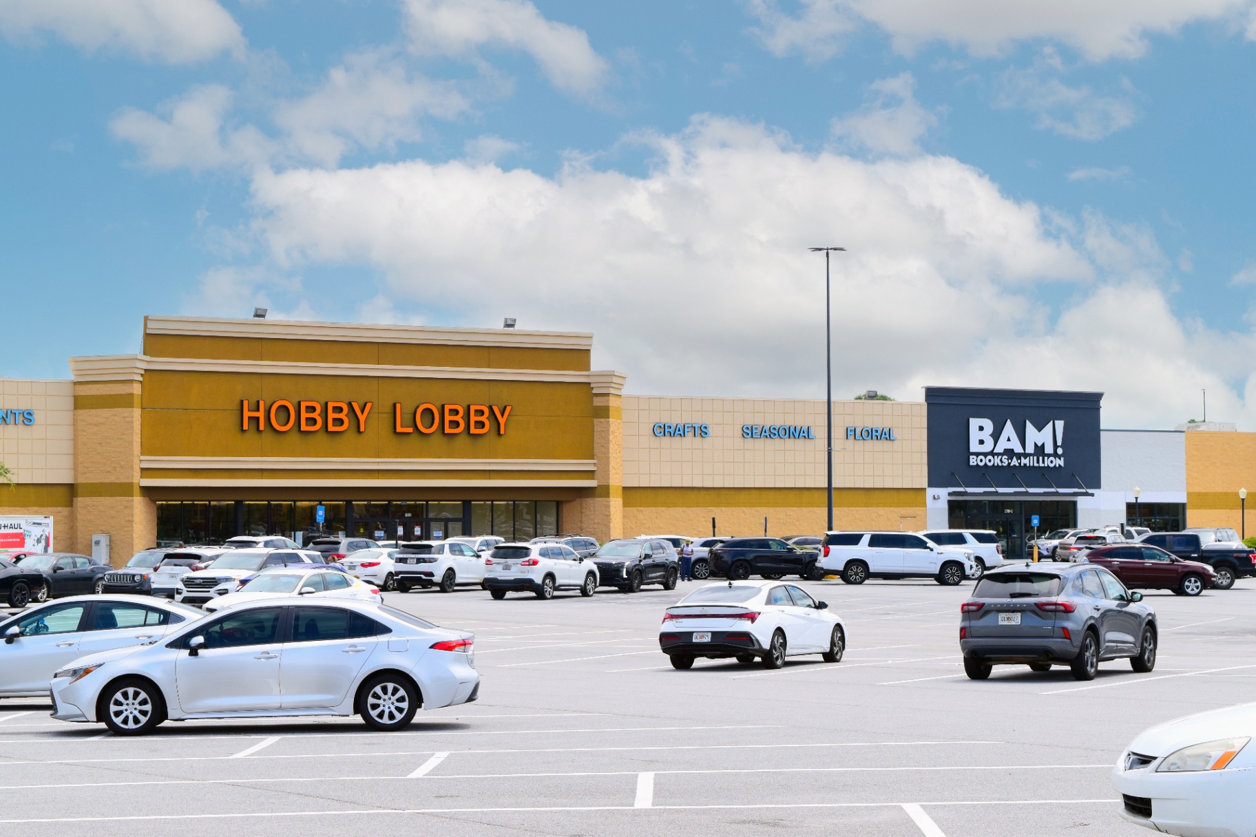 Hobby Lobby and Books-A-Million storefronts along the parking field